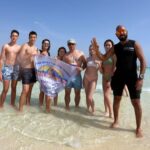Tourists enjoying a luxury yacht excursion to Ras Mohammed National Park and White Island in Sharm El Sheikh with snorkeling, diving, coral reefs, tropical fish, and crystal-clear Red Sea water. STAR KHATTABYCH TOURS