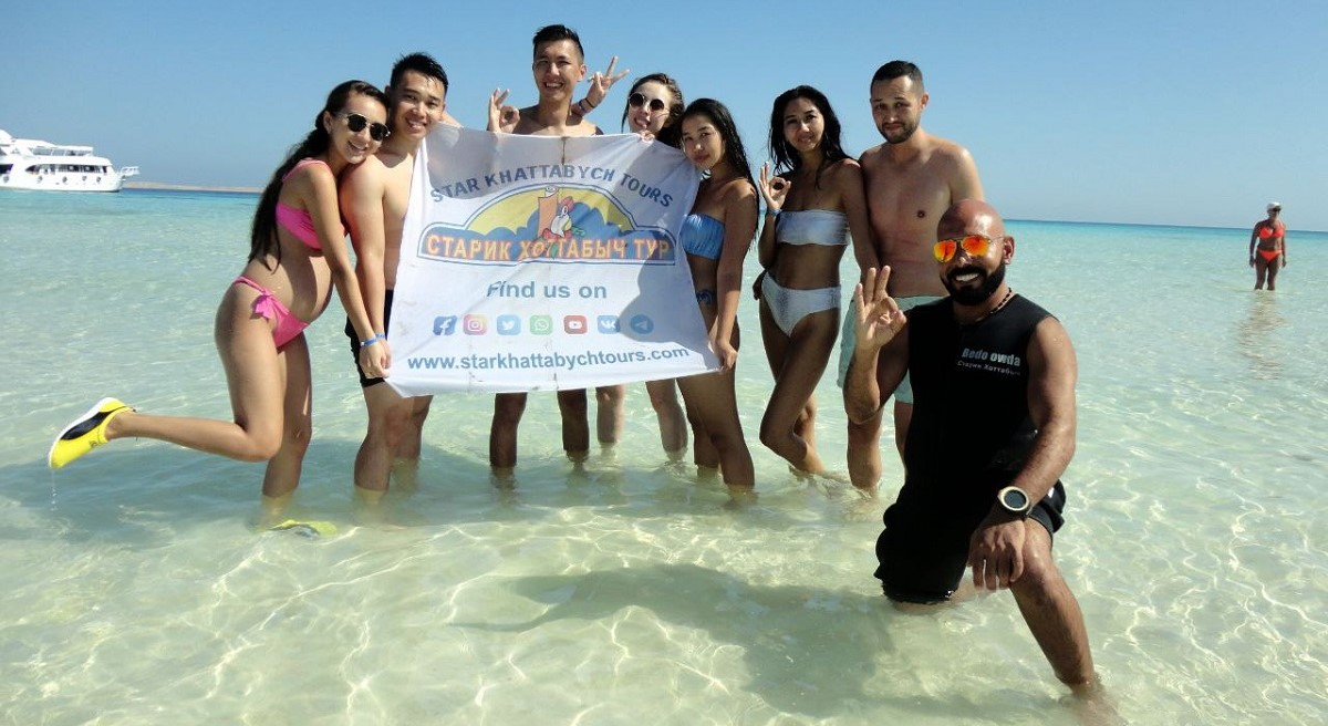 Tourists enjoying a luxury yacht excursion to Ras Mohammed National Park and White Island in Sharm El Sheikh with snorkeling, diving, coral reefs, tropical fish, and crystal-clear Red Sea water. STAR KHATTABYCH TOURS Tourists enjoying a luxury yacht excursion to Ras Mohammed National Park and White Island in Sharm El Sheikh with snorkeling, diving, coral reefs, tropical fish, and crystal-clear Red Sea water. STAR KHATTABYCH TOURS