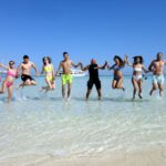 Tourists enjoying a luxury yacht excursion to Ras Mohammed National Park and White Island in Sharm El Sheikh with snorkeling, diving, coral reefs, tropical fish, and crystal-clear Red Sea water. STAR KHATTABYCH TOURS