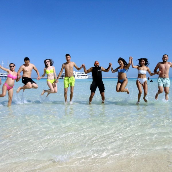 Tourists enjoying a luxury yacht excursion to Ras Mohammed National Park and White Island in Sharm El Sheikh with snorkeling, diving, coral reefs, tropical fish, and crystal-clear Red Sea water. STAR KHATTABYCH TOURS Tourists enjoying a luxury yacht excursion to Ras Mohammed National Park and White Island in Sharm El Sheikh with snorkeling, diving, coral reefs, tropical fish, and crystal-clear Red Sea water. STAR KHATTABYCH TOURS